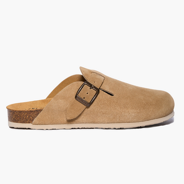 A Tan suede clog shoe with a buckle-up closure, adjustable strap, a flat cork insole and EVA outsole. Handmade in Spain
